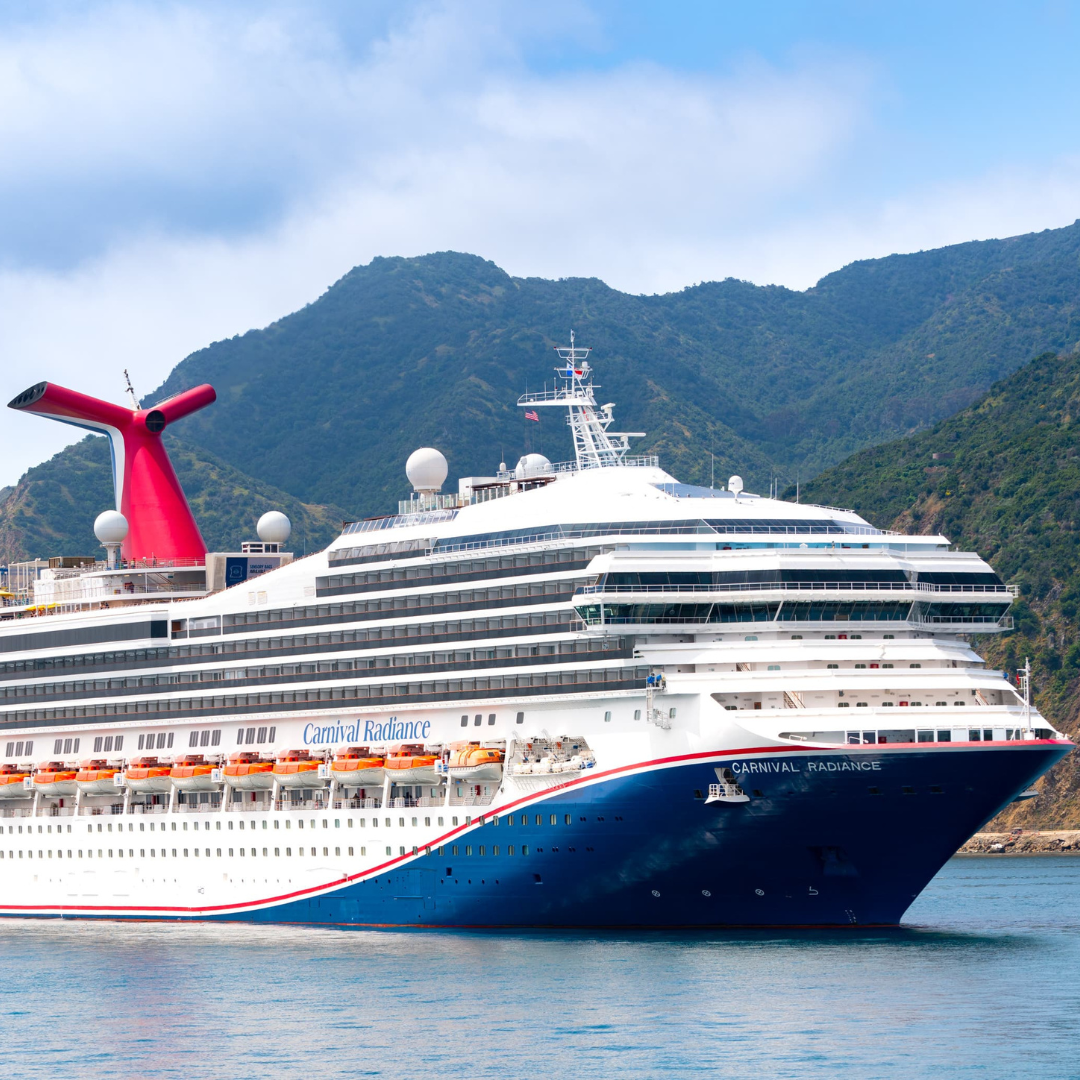 white cruise ship with big red fin in the back